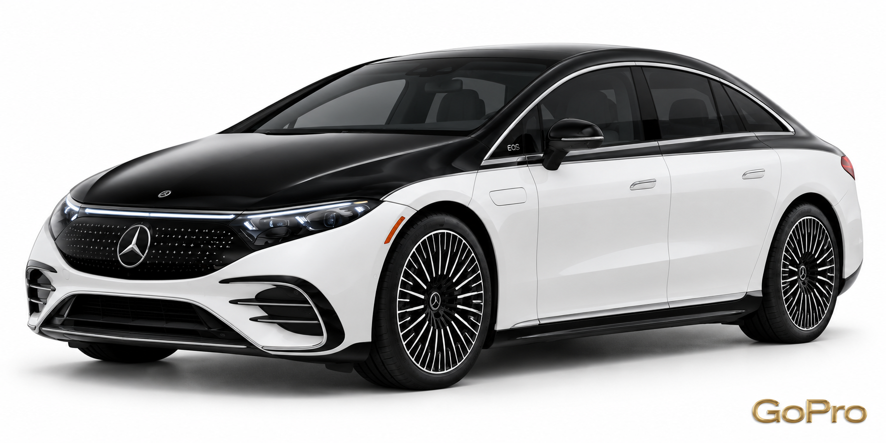 White and black Mercedes-Benz EQS luxury sedan in a studio shot